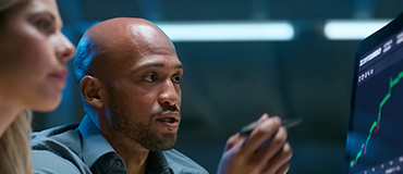 Man showing something to a woman on a computer screen